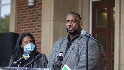 Stockbridge City Councilmembers John Blount, right, and LaKeisha Grant call for the resignation of Stockbridge Mayor Pro Tem Elton Alexander on Friday during a press conference on the front steps of Stockbridge City Hall. (Alyssa Pointer / Alyssa.Pointer@ajc.com)