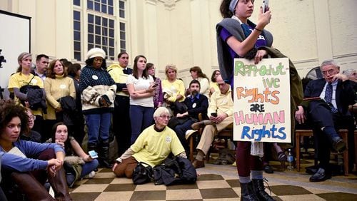In this 2017 photo, Gragiela Valencia, a then-sophomore at Trinity College, was one of many students that attended a crowded council meeting at city hall as Hartford sought to crack down on faith-driven crisis pregnancy centers, which critics say sometimes pose as clinics to lure women and hand out misleading information about abortions. In 2022, $2 million in public funds was allocated to the 89 crisis pregnancy centers in Georgia.  (John Woike/Hartford Courant/TNS)