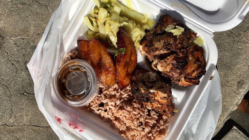 A plate of jerk chicken served with rice and peas, steamed cabbage, and ripe plantains at Irie Mon Cafe. PHOTO CREDIT: Wyatt Williams