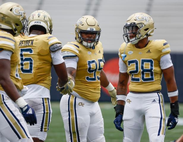 Team Swarm defenders Etinosa Reuben (6), Jason Moore (95) and Jaylin Marshall (28) huddle during Georgia Tech's spring football game in Atlanta on Saturday, April 15, 2023.   (Bob Andres for the Atlanta Journal Constitution)