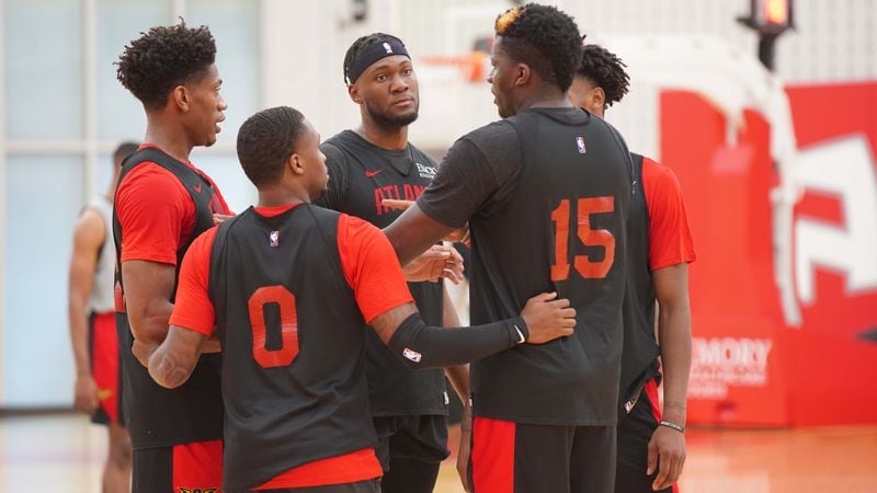 Hawks players gather around center Clint Capela (15) during a huddle at team practice Monday, Sept. 28, 2020, in Atlanta. Hawks players went into a "bubble" environment as a team in order to hold workouts during the pandemic.