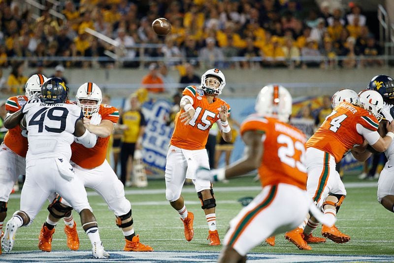 ORLANDO, FL - DECEMBER 28: Brad Kaaya #15 of the Miami Hurricanes passes against the West Virginia Mountaineers in the second quarter of the Russell Athletic Bowl at Camping World Stadium on December 28, 2016 in Orlando, Florida. (Photo by Joe Robbins/Getty Images)