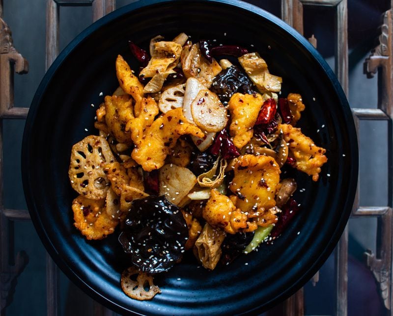The fish spicy pot at Xin’s Chinese Cuisine, which includes crispy fried fish, wood ear mushrooms, lotus root, peanuts and a secret chile oil blend, is the most popular item on the menu. CONTRIBUTED BY HENRI HOLLIS