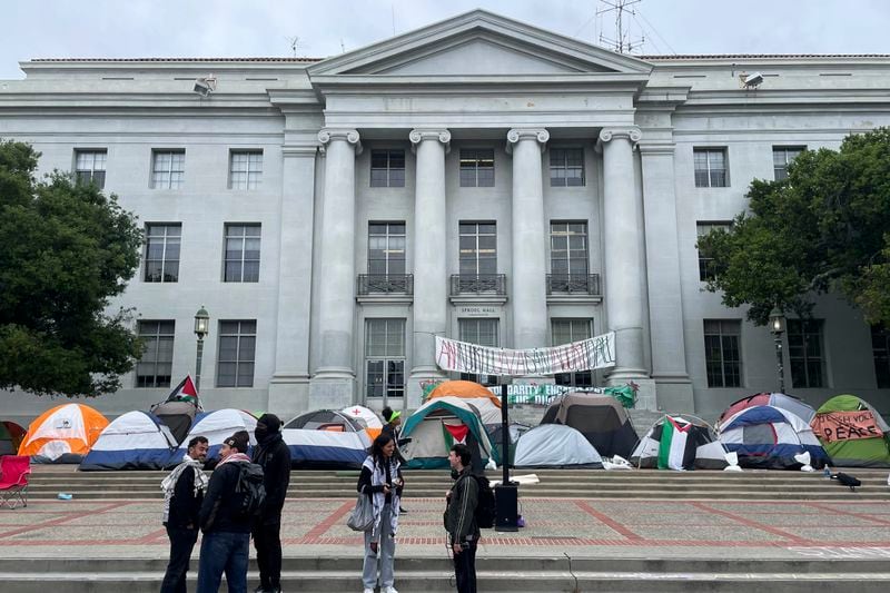 Pro-Palestinian protesters gather near an encampment set up in front of Sproul Hall on the campus of the University of California, Berkeley in Berkeley, Calif., Tuesday, April 23, 2024. The Israel-Hamas war protests creating friction at universities across the United States escalated Tuesday as some colleges encouraged students to attend classes remotely and dozens faced charges after setting up tents on campuses and ignoring official requests to leave. (AP Photo/Haven Daley)