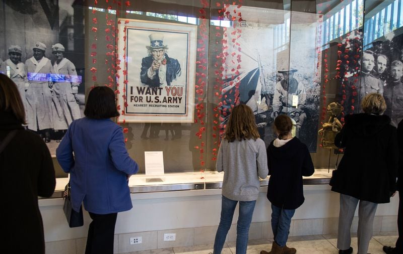 People look over information for the Veterans History Project in the atrium of the Atlanta History Center after the 2018 Veterans Day Commemoration on Sunday, November 11, 2018. (Photo: STEVE SCHAEFER / SPECIAL TO THE AJC)