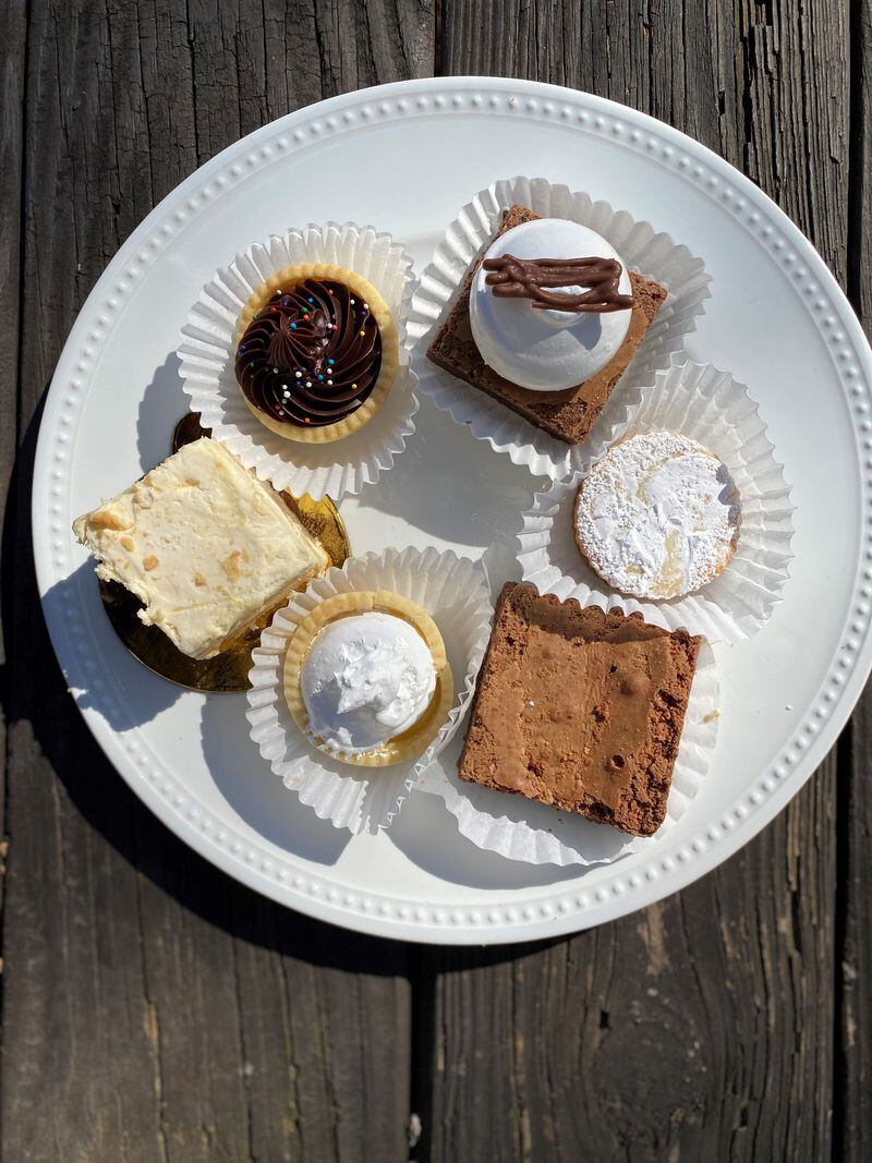 Clockwise from the upper right, this plate of Belen de la Cruz sweets includes a marquis, alfajor, brownie, lemon bite, lemon cake and a havannet. Wendell Brock for The Atlanta Journal-Constitution
