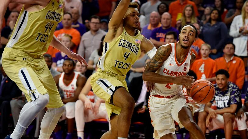 Clemson's Marcquise Reed, right, drives to the basket while defended by Georgia Tech's Brandon Alston, center, and Ben Lammers during the second half of an NCAA college basketball game Saturday, Feb. 24, 2018, in Clemson, S.C. (AP Photo/Richard Shiro)
