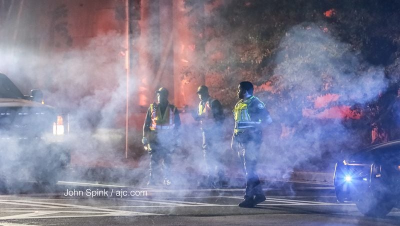 Atlanta police and fire officials responded to a fiery crash Wednesday in Fulton County. JOHN SPINK / JSPINK@AJC.COM