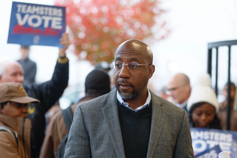 Sen. Raphael Warnock speaks to the media during a campaign rally at the UPS Smart Hub facility in Atlanta on Monday, December 5, 2022. (Natrice Miller/natrice.miller@ajc.com)  