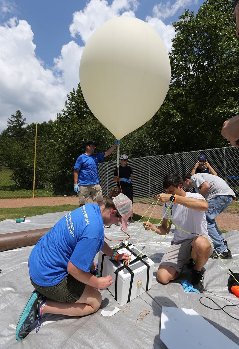 Georgia Tech students and alumni prepare to launch a balloon to 100,000 feet for an experiment that conducted during Monday’s total solar eclipse. They staged the launch at  Ramah Darom, a Jewish summer camp/event facility in Rabun County. CURTIS COMPTON / CCOMPTON@AJC.COM