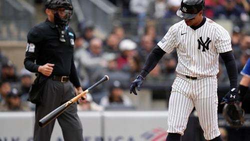 New York Yankees' Juan Soto throws his bat after striking out during the eighth inning of the baseball game against the Toronto Blue Jays at Yankee Stadium Friday, April 5, 2024, in New York. (AP Photo/Seth Wenig)