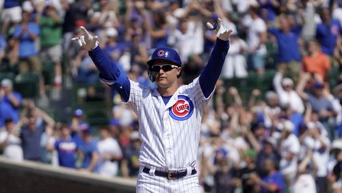 Chicago Cubs' Joc Pederson looks around Wrigley Field and celebrates his two-run double off St. Louis Cardinals relief pitcher Genesis Cabrera during the seventh inning of a baseball game Friday, June 11, 2021, in Chicago. (AP Photo/Charles Rex Arbogast)
