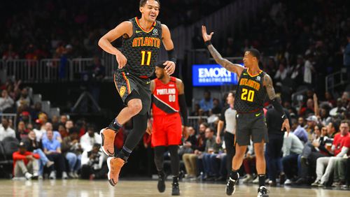 Atlanta Hawks guard Trae Young (11) reacts after a long range assist during the second half of an NBA basketball game against thePortland Trail Blazers, Saturday, Feb. 29, 2020, in Atlanta. (AP Photo/John Amis)