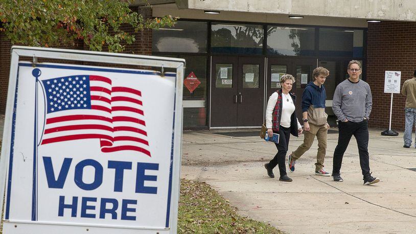 Jeff Brown (right), his wife Melony Brown (left) and their son Palmer Brown, leave Campbell Middle School after Jeff and Melony casted their ballots during Election Day in Smyrna, Tuesday, November 5, 2019. (Alyssa Pointer/Atlanta Journal Constitution)