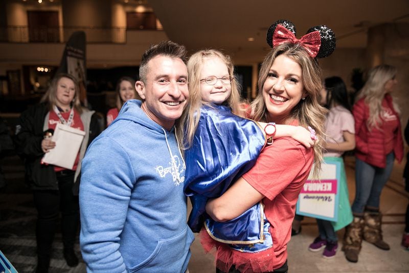 The Bert Show host Bert Weiss (left), and co-host Kristin Klingshirn (right), pose with a Bert’s Big Adventure child during a family welcome night event at the Renaissance Concourse Atlanta Airport Hotel in 2019. The nonprofit is sponsoring Your Space Virtual Race on July 4. Contributed by Bert’s Big Adventure.