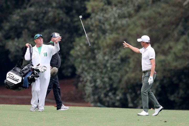 April 10, 2021, Augusta: Justin Thomas tosses his club to his caddie James Johnson after his fairway shot on the eighteenth hole during the third round of the Masters at Augusta National Golf Club on Saturday, April 10, 2021, in Augusta. Curtis Compton/ccompton@ajc.com