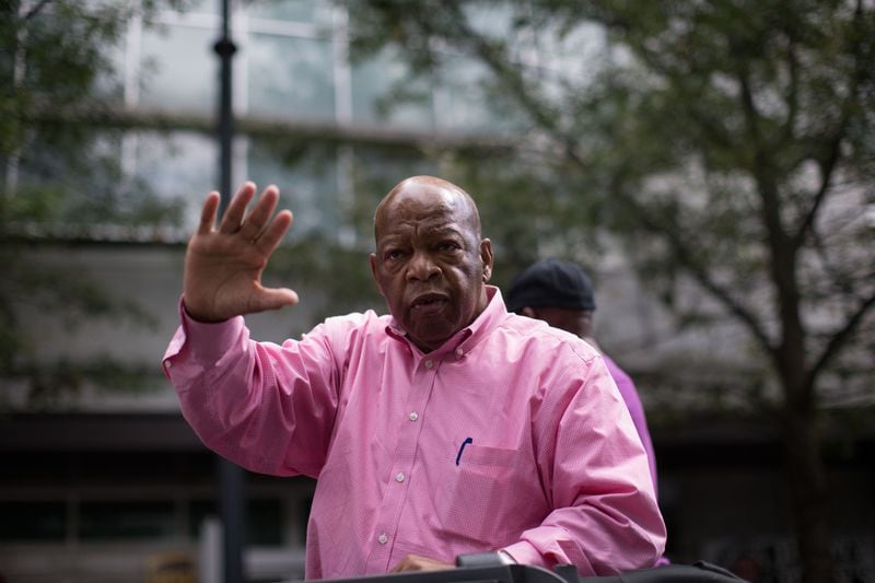 Rep. John Lewis waves to the crowd as he rides down Peachtree Street during the Atlanta Pride Parade, Sunday, Oct. 11, 2015. BRANDEN CAMP/SPECIAL