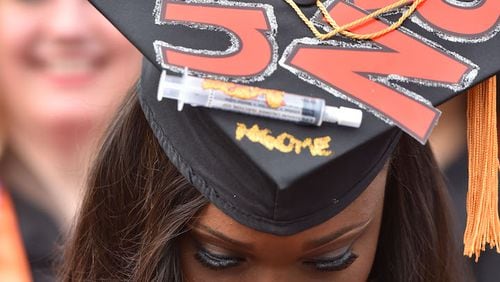 In this file photo, Nursing student Yvonne Ngome wears a personalized mortar board during Mercer University’s Atlanta campus commencement. Georgia’s colleges and universities offer myriad nursing-related degrees and certifications.