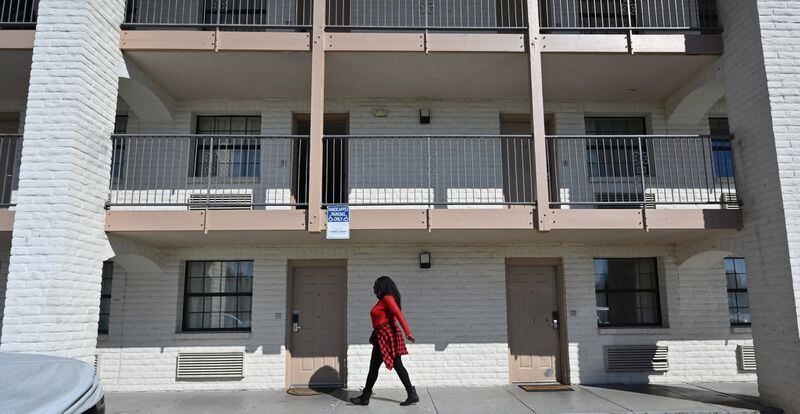 A resident recently walked past an extended stay motel window in Norcross.  For low-wage workers, extended stay has been an alternative to homelessness, but many have lost their jobs.  (Hyosub Shin / Hyosub.Shin@ajc.com)