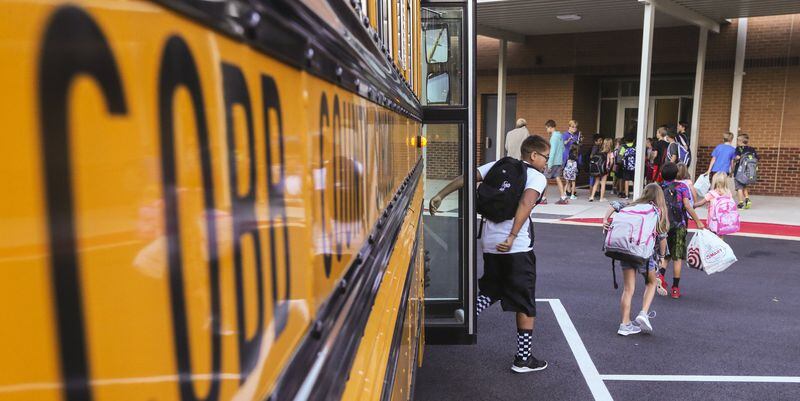 Cobb County schools started back to school Monday. In this photo, students arrive for class at Mountain View Elementary School on Sandy Plains Road in Cobb County. JOHN SPINK / JSPINK@AJC.COM.