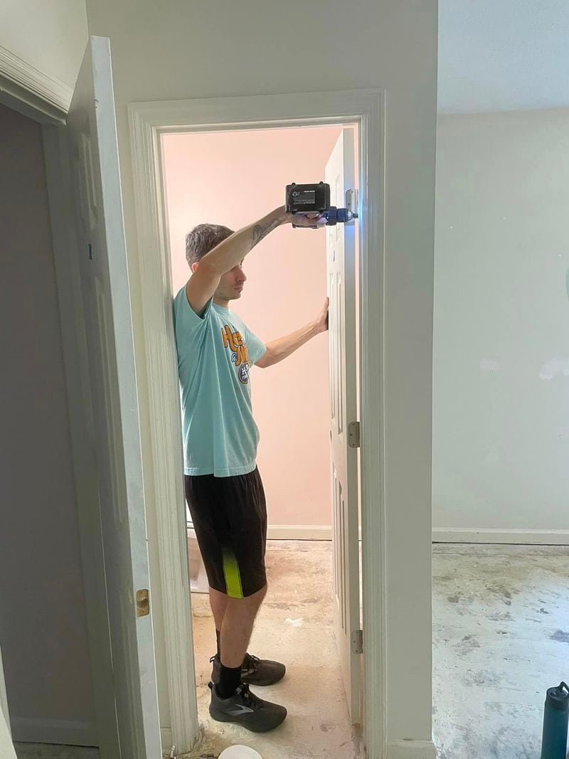 A volunteer hangs a door in Tharros Place, a home for survivors of sex trafficking and at-risk teenage girls in Savannah. (Photo courtesy of Tharros Place)