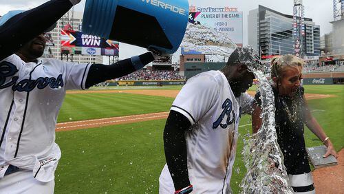 Matt Kemp pours a cooler of water on Brandon Phillips after Phillips’ walk-off hit beat the Marlins on Sunday. On Wednesday, it was Kemp delivering an 11th-inning walk-off homer to beat the Giants. (Curtis Compton/ccompton@ajc.com)