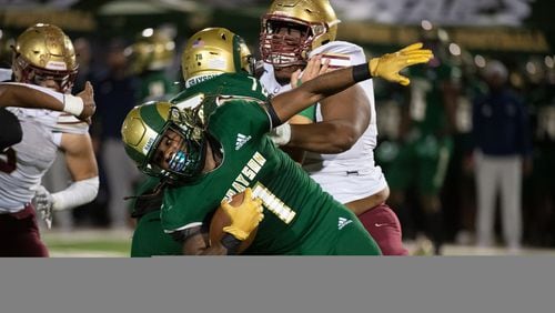 Joe Taylor Jr., running back for Grayson avoids being tackled during the Grayson vs. Brookwood High School Football game on Friday, Oct. 21, 2022, at Grayson High School in Loganville, Georgia. (Jamie Spaar for the Atlanta Journal Constitution)