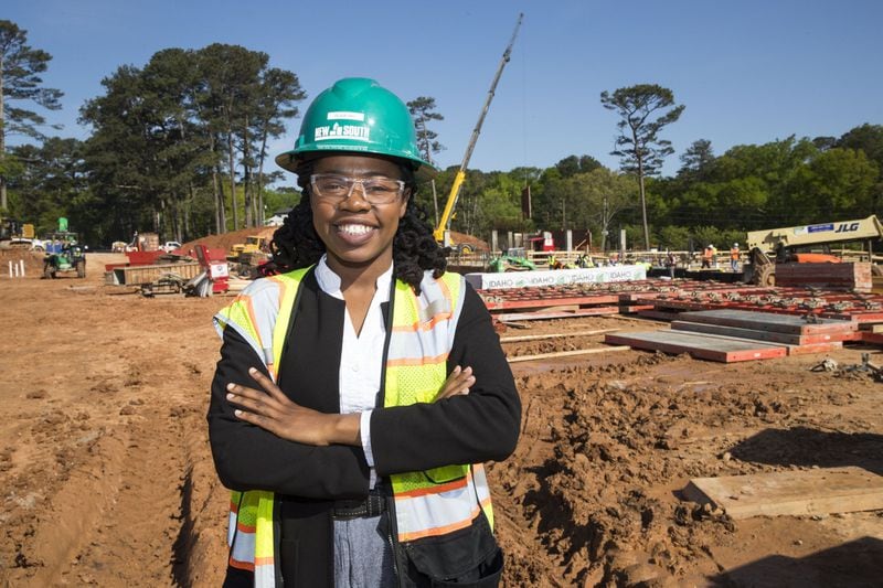 New South Construction project manager Olivia Fru poses for a portrait at the construction site for Peachtree Hills Place, a 55+ living community in the Peachtree Hills Atlanta neighborhood , Wednesday. Fru, a graduate from Southern Polytechnic State University, says she became interested in construction at a young age. She says she enjoyed watching structures go up while living in Camaroon. “It’s like playing Lego,” says Olivia. ALYSSA POINTER/ALYSSA.POINTER@AJC.COM