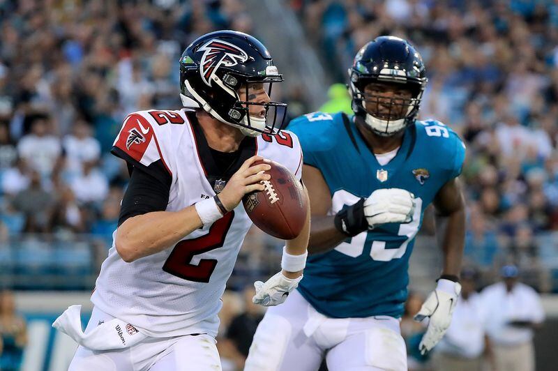  Matt Ryan of the Atlanta Falcons is pressured by Calais Campbell  of the Jacksonville Jaguars during a preseason game at TIAA Bank Field on August 25, 2018 in Jacksonville, Florida.  (Photo by Sam Greenwood/Getty Images)