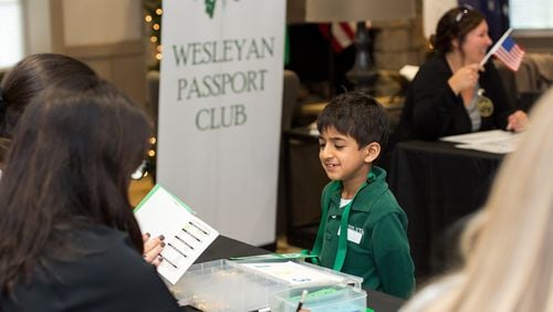 Wesleyan School student Sal Agarwal answers questions about countries he’s learned through the Passport Club, a program that promotes the study of countries around the globe. Students who master the material receive passport stamps and points they can redeem at a year-end bazaar. Photo courtesy of Wesleyan School.