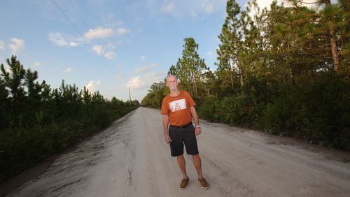 Dennis Perry on the side of the road near the Satilla River, where he grew up fishing.(Tyson Horne / tyson.horne@ajc.com)
