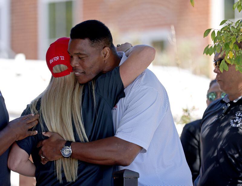 Republican U.S. Senate candidate Herschel Walker hugs former University of Kentucky swimmer Riley Gaines during a rally in Canton. Gaines, a 12-time NCAA All-American swimmer, campaigned with Walker multiple times, speaking out against biological males participating in women’s sports. (Jason Getz / Jason.Getz@ajc.com)