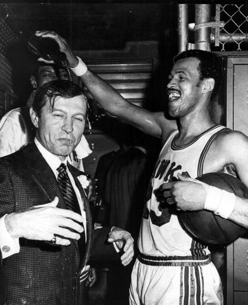 In this 1960s photo, Atlanta Hawks player Lou Hudson poured celebratory champagne over team owner and gubernatorial candidate Carl Sanders. The photo was mysteriously distributed statewide to demonstrate Sanders ties to Atlanta and black people. AJC FILE PHOTO