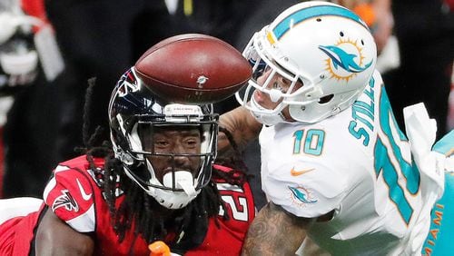 Atlanta Falcons cornerback Desmond Trufant (21) breaks up the catch against Miami Dolphins wide receiver Kenny Stills (10) during the first half of an NFL football game, Sunday, Oct. 15, 2017, in Atlanta. (AP Photo/David Goldman)