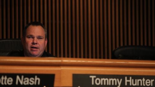 Commissioner Tommy Hunter listens to Gwinnett county residents who came Tuesday to speak out against his words aimed at John Lewis on Facebook. (HENRY TAYLOR / HENRY.TAYLOR@AJC.COM)