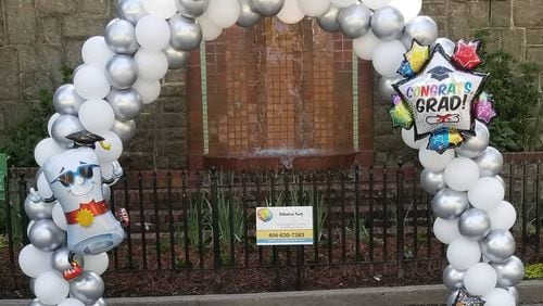 Grant Park resident Maureen Dougher decided to turn a negative into a positive by posting a pop-up balloon display in Grant Park near the Milledge Fountain for graduates to use as a picture backdrop.