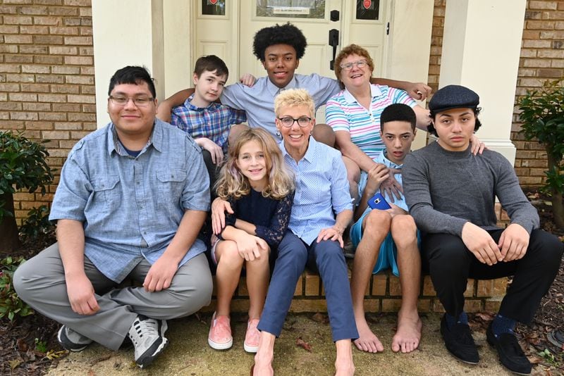 Carol (front row center) and Judy (back row right) Veschi with their adopted children (front row from left) John, 18, Gaby, 10, Mikey, 13, Steven, 19, (back row from left) Rio, 11, and Aaron, 14, at their home in Alpharetta on Wednesday, September 9, 2020. (Hyosub Shin / Hyosub.Shin@ajc.com)