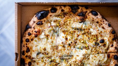 The potato pizza from Grana also features goat cheese, truffle honey, thinly-sliced red onion and pistachios. CONTRIBUTED BY HENRI HOLLIS