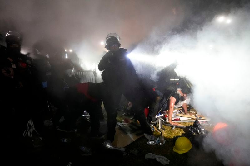 Police enter an encampment set up by pro-Palestinian demonstrators on the UCLA campus Thursday, May 2, 2024, in Los Angeles. (AP Photo/Jae C. Hong)