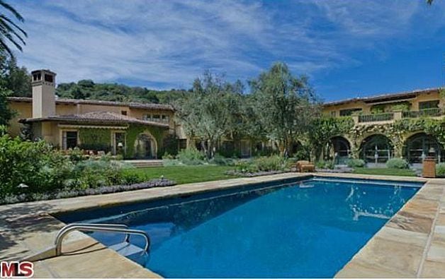 Mediterranean-style home features pool, spa