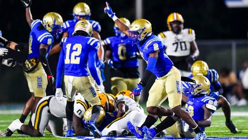 The McEachern Indians react to a recovered fumble against Valdosta in the second half of their game Friday, September 22, 2023. (Photo by Daniel Varnado/For the AJC)