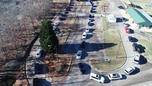 A long line of cars during recent drive-through COVID testing in McDonough. As omicron cases surge, some metro Atlanta employers are rethinking plans to reopen offices or keep workers coming in. Photo courtesy of Henry County government