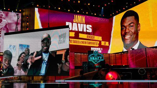 Images of Kentucky linebacker Jamin Davis are shown on stage after he was chosen by the Washington Football Team with the 19th pick in the first round of the NFL draft Thursday April 29, 2021, in Cleveland. (Tony Dejak/AP)