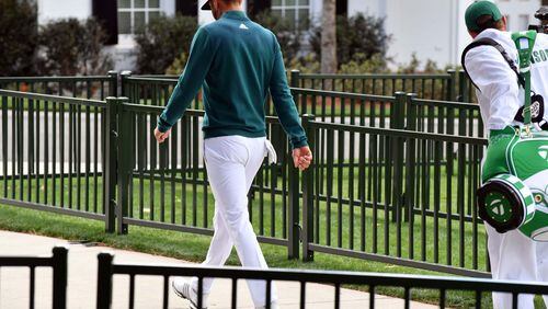 Dustin Johnson walks off the first tee after deciding not to play in the opening round of the 81st Masters tournament at the Augusta National Golf Club on Thursday. (Brant Sanderlin/Special)
