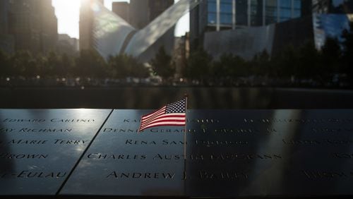 An American flag was left at the North pool memorial site before a commemoration ceremony for the victims of the September 11 terrorist attacks at the National September 11 Memorial, September 11, 2017 in New York City.