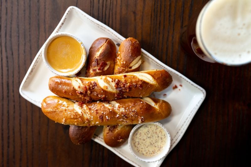 The Lost Druid Tavern Pretzels, four German Laugen loaf-style hot pretzels sprinkled with bacon salt, served with lager mustard and jalapeno cheese sauce.