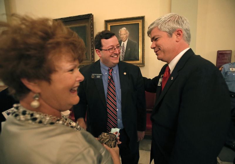 March 22, 2013 - Atlanta, Ga: Sen. Joshua McKoon, R-Columbus, center, celebrates the passage of House Bill 142 with conservative activists Kay Godwin, left, and executive director of Common Cause William Perry, right, outside of the Senate Chambers during Legislative Day 37 Friday afternoon in Atlanta, Ga., March 22, 2013. The Senate approved ethics reforms Friday with a vote of 52-0 to limit the influence of political lobbyists across Georgia. Sen. McKoon has been an advocate for ethics reform ever since he became a senator in 2010. The Senate changed most of House Speaker David Ralston's ethics reform bill stripping most of the bill's key provisions including a ban on one-on-one lobbyists gifts and replacing it with a $100 cap. JASON GETZ / JGETZ@AJC.COM