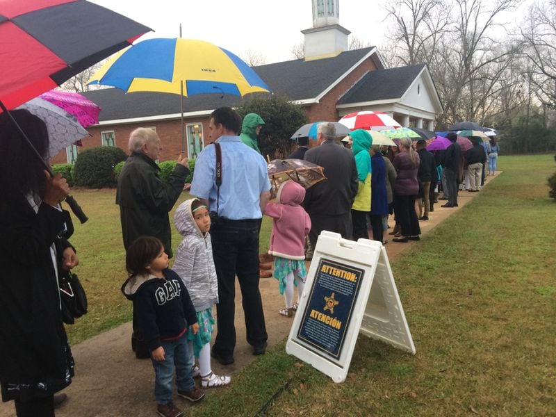 The beginning of the line to attend a recent Sunday school class taught by former President Jimmy Carter. More than 300 people showed up hours early on a rainy morning in March. Jill Vejnoska/AJC