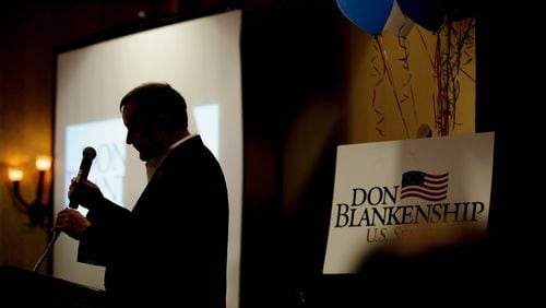 Don Blankenship, a Republican primary candidate for the U.S. Senate in West Virginia, replaces the microphone after addressing supporters on Tuesday. Jeff Swensen/Getty Images