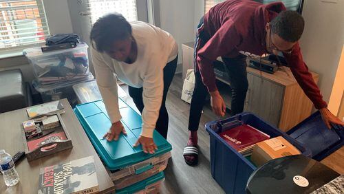 Morehouse College senior John Bowers (right) and his mother, Rhetta Andrews Bowers, a state representative from Dallas, Texas, pack up his belongings from his off-campus apartment on Tuesday, March 17, 2020. Bowers, Morehouse’s student government association president, has been helping students who need temporary housing and other resources as Morehouse and other colleges close their campuses in response to the coronavirus outbreak.